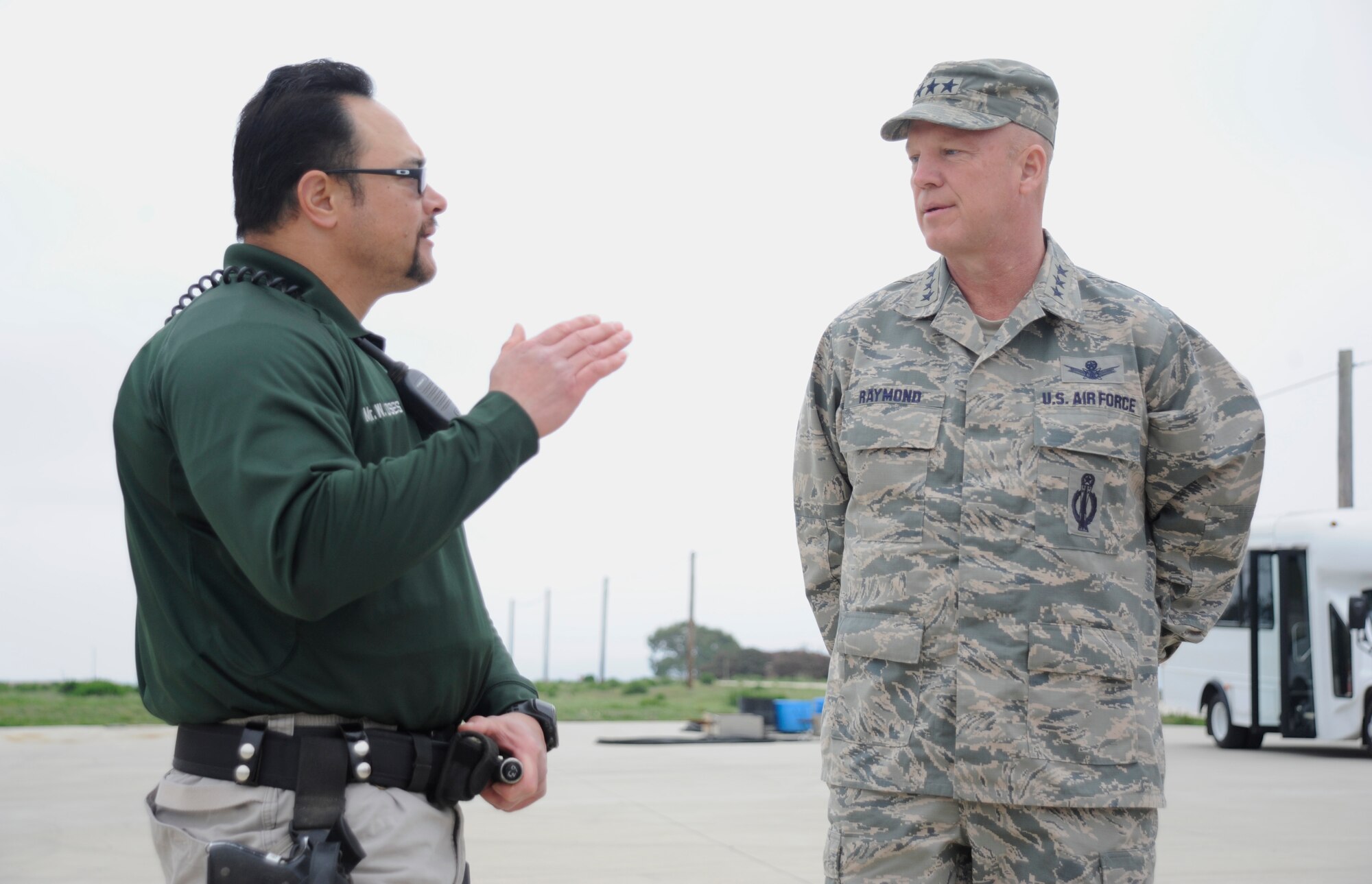 Wayne Moses, 30th Security Force Squadron conservation law enforcement officer, briefs Lt. Gen. John Raymond, Commander, 14th Air Force (Air Forces Strategic) and Joint Functional Component Command for Space, during a base tour, Feb. 17, 2015, Vandenberg Air Force Base, Calif. Moses explained the various capabilities of the conservation office. (U.S. Air Force Photo by Airman Robert J. Volio/Released)