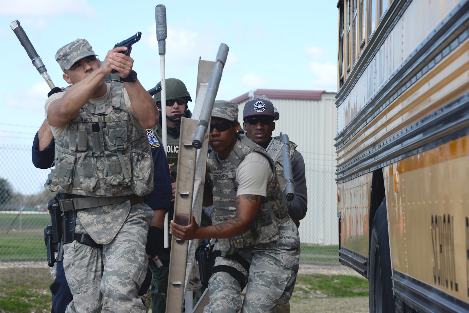 Members of the 902nd and 802nd Security Forces Squadrons train with members of local police departments during a bus assault and hostage rescue exercise Feb. 19, 2015, at Joint Base San Antonio-Randolph Camp Talon. The local agencies involved in the exercise were from the cities of Live, Oak Universal City and Converse and the Judson Independent School District Police Departments. Security Forces and local police departments trained together to prepare for emergencies that require both military and civilian response efforts. (U.S. Air Force photo by Airman 1st Class Stormy Archer/Released)
