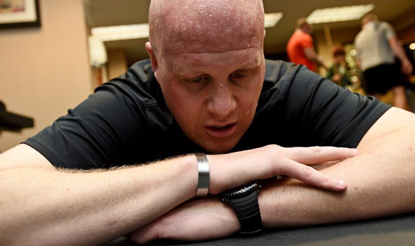 Senior Master Sgt. Ryan Carson, U.S. Air Force Band Max Impact vocalist, rests after a work-out at the Holiday Inn Hotel and Suites gym in Mesa, Ariz., Jan. 31, 2015. Max Impact members utilize the fitness application’s group profile to keep track of one another’s daily health goals. (U.S. Air Force photo/ Senior Airman Nesha Humes)