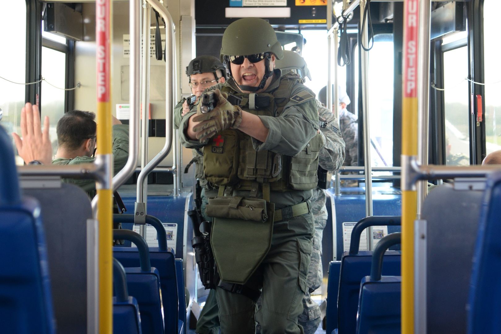 Officer Sergio Pena, City of Windcrest Police Department patrolman, leads a boarding party onto a city bus during a bus assault and hostage rescue exercise Feb. 19, 2015, at the Joint Base San Antonio-Randolph Camp Talon. The local agencies involved in the exercise were from the cities of Live, Oak Universal City and Converse and the Judson Independent School District Police Departments. Security Forces and local police departments trained together to prepare for emergencies that require both military and civilian response efforts. (U.S. Air Force photo by Airman 1st Class Stormy Archer/Released)

