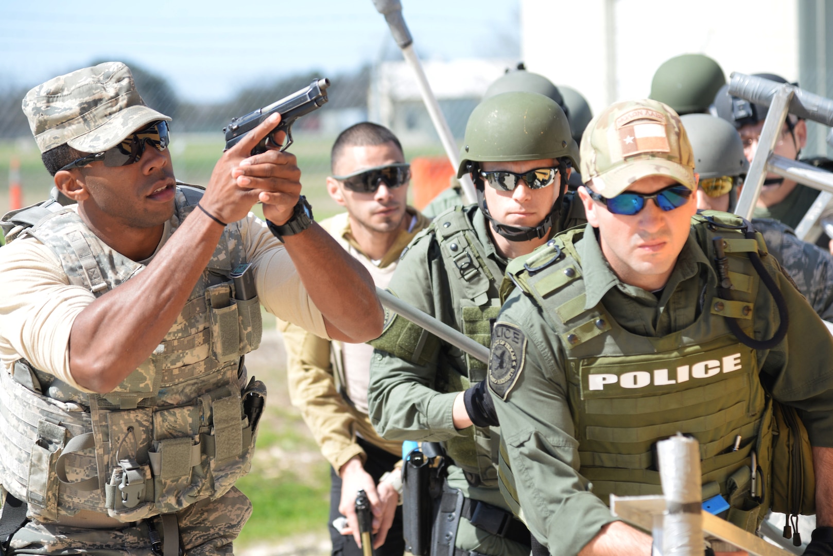 Members of the 902nd and 802nd Security Forces Squadrons train with members of local police departments during a bus assault and hostage rescue exercise Feb. 19, 2015, at Joint Base San Antonio-Randolph Camp Talon. The local agencies involved in the exercise were from the cities of Live, Oak Universal City and Converse and the Judson Independent School District Police Departments. Security Forces and local police departments trained together to prepare for emergencies that require both military and civilian response efforts. (U.S. Air Force photo by Airman 1st Class Stormy Archer/Released)
