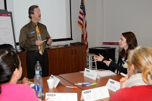 Roger Bullis, Army Community Service community readiness consultant, teaches resilience training to U.S. Army spouses at ACS at Fort Eustis, Va., Feb. 23, 2014. The Spouse Resilience Training seminar provides the same training Soldiers learn when they first arrive on a new duty station. (U.S. Air Force photo by Staff Sgt. Teresa J. Cleveland/Released)
