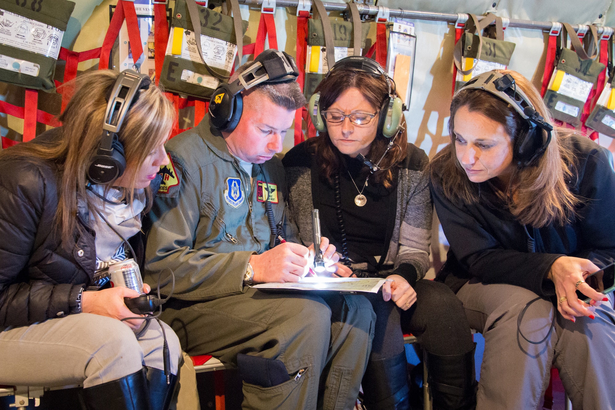 Master Sgt. Ben Brent, 465th Air Refueling Squadron explains the air route to wing spouses during a spouse orientation flight here Feb. 7.  This flight was one of the first spouse flights the wing hosted in many years.  (Courtesy Photo/Gayle Robbins)