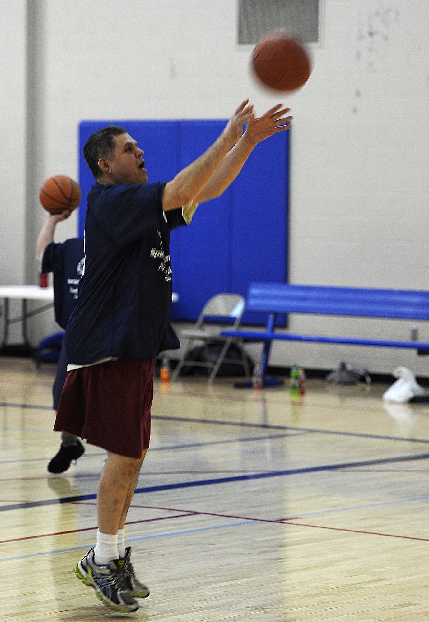 MINOT AIR FORCE BASE, N.D. -- Lenny Landaker, a Special Olympics athlete, shoots the ball during warm-ups before his game in the regional basketball tournament at the McAdoo Fitness Center on Minot Air Force Base, N.D., Feb. 21, 2015. The tournament was a stepping stone to the state-level competition, which will be held next month in downtown Minot. (U.S. Air Force photo/Senior Airman Kristoffer Kaubisch) 