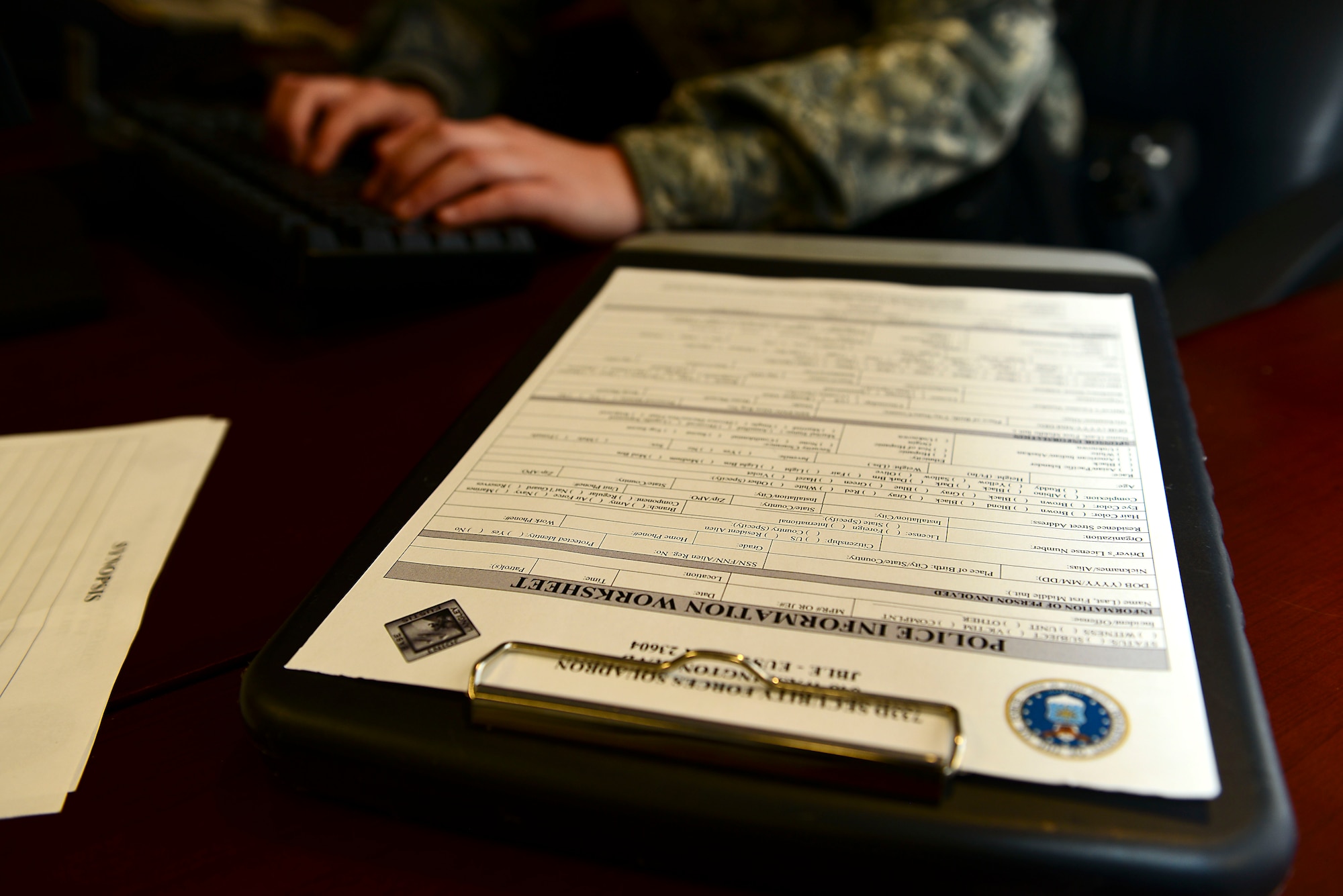 U.S. Army Spc. Charlotte Dewyea, 221st Military Police Detachment patrolman, enters information from a Police Information Worksheet into a database at Fort Eustis, Va., Feb. 12, 2015. The worksheet is completed and filed into the system each time an MP or 733rd Security Forces Squadron member responds to an incident. (U.S. Air Force photo by Senior Airman Kimberly Nagle/Released) 