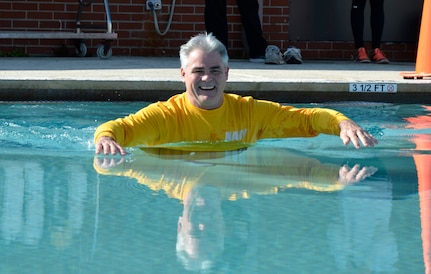 Captain Timothy Sparks, Joint Base Charleston deputy commander smiles as he swims across the New Wave Aquatic Center pool after completing the 5K run and Polar Plunge at Sam's Fitness Center on Joint Base Charleston-Weapons Station, Feb. 21, 2015. There were approximately 20 participants in the Sam's Fitness Center inaugural Fun Run and Polar Plunge. The temperature for the day was in the low to mid 60s. (Courtesy photo/Jessica Donnelly)
