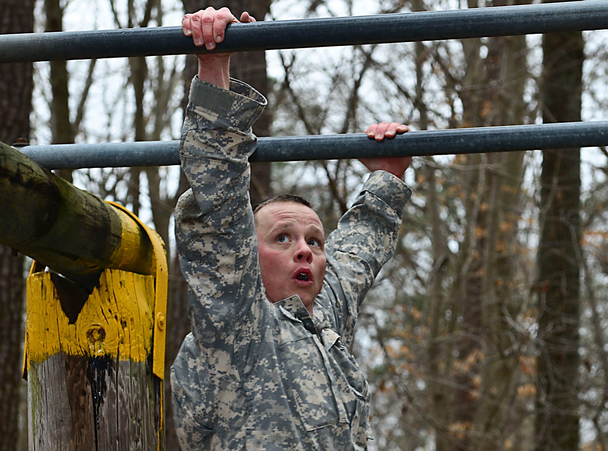 U.S. Army Sgt.1st Class Christopher Wells, Bravo Company, 1st Battalion, 210th Aviation Regiment, 128th Aviation Brigade instructor, attempts the final obstacle at the confidence course at Fort Eustis, Va., Feb. 12, 2015. Soldiers had to complete the course as quickly and accurately as possible as part of the annual 128th Avn. Bde. noncommissioned officer and Advanced Individual Training Platoon sergeant competition. (U.S. Air Force photo by Senior Airman Kimberly Nagle/Released)