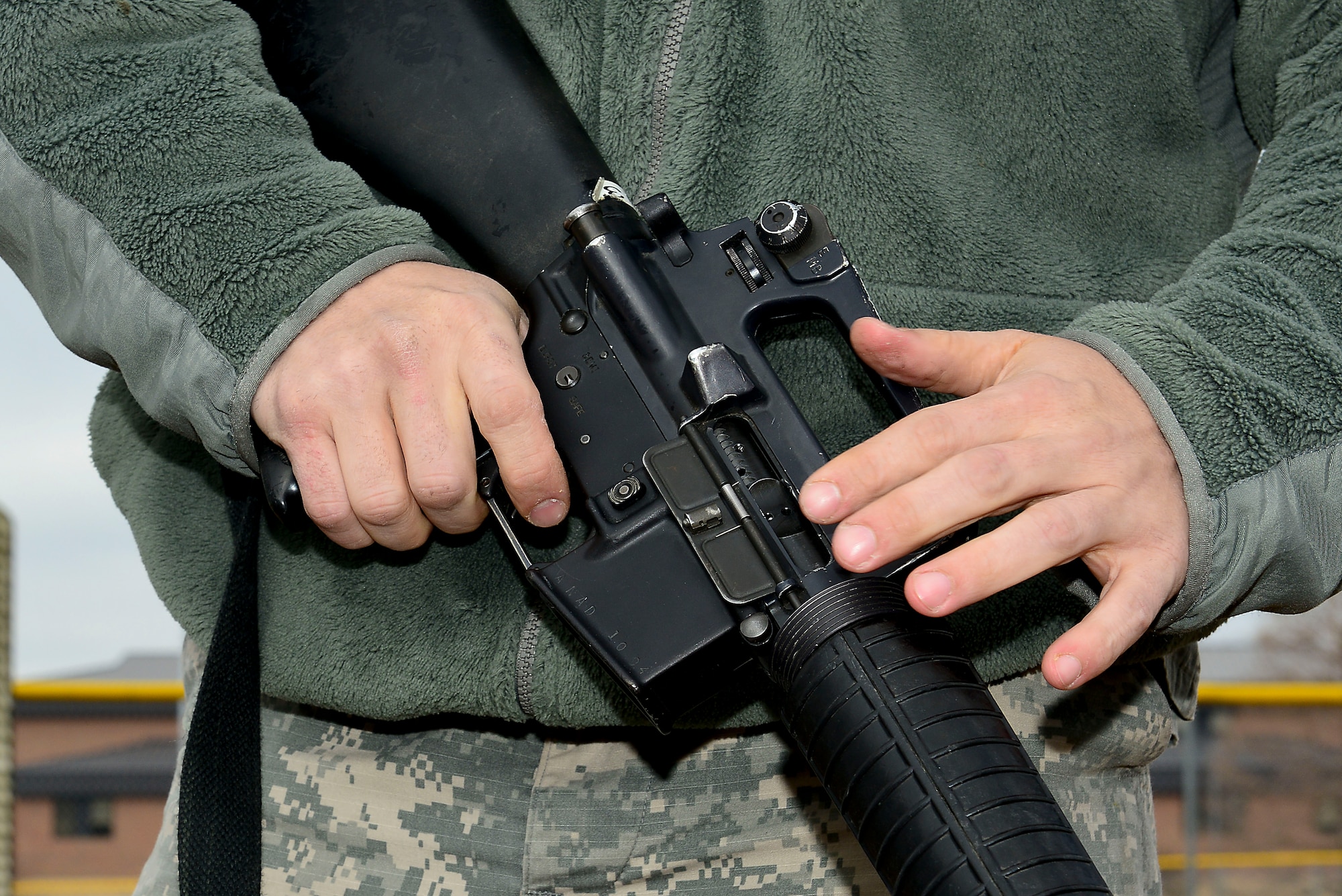 U.S. Army Staff Sgt. Thomas Featsent, Bravo Company, 1st Battalion, 210th Aviation Regiment, 128th Aviation Brigade UH-60 Blackhawk maintenance instructor shows his weapon to a judge during the annual 128th Avn. Bde. noncommissioned officer and Advanced Individual Training Platoon sergeant competition at Fort Eustis, Va., Feb. 11, 2015. During the competition, NCO’s completed tasks including improvised explosive device response, a physical fitness test and a board judged by sergeants major. (U.S. Air Force photo by Senior Airman Kimberly Nagle/Released)