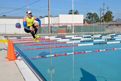 The lead participant cannonballs into the New Wave Aquatic Center pool at Sam's Fitness Center on Joint Base Charleston-Weapons Station, Feb. 21, 2015 after completing the 5K run. Approximately 20 participants came out for the inaugural 5K Fun Run and Polar Plunge event and braved the chilly temps of the water after a run through base housing. (Courtesy photo/Jessica Donnelly

