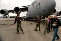 The Faull family receives a tour of a C-17 Globemaster III, Feb. 20, 2015 at Joint Base Lewis-McChord.  Carver Faull (fourth from the right) was honored through the Pilot for a Day Program and received a tour of many of the operations on McChord Field. (U.S. Air Force photo /Staff Sgt. Tim Chacon)