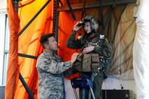 Carver Faull, participant in the Pilot for a Day program, looks into the virtual reality goggles he’ll use to complete his simulated Survival, Evasion, Resistance and Escape parachute training, Feb. 20, 2015, at Joint Base Lewis-McChord, Wash. The goggles simulated falling from 4,000 feet, and Carver’s goal was to navigate the parachute to the sand for a soft landing. (U.S. Air Force photo/Senior Airman Rebecca Blossom)