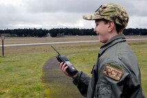 Carver Faull, a participant in the Pilot for a Day program on McChord Field, smiles after members of the 627th Civil Engineer Squadron’s explosive ordinance disposal team let him make the call to detonate explosives, Feb. 20, 2015, at Joint Base Lewis-McChord, Wash. After Carver called the detonation over the radio, two and a half pounds of C-4 ignited from across the air field. (U.S. Air Force photo/Senior Airman Rebecca Blossom) 