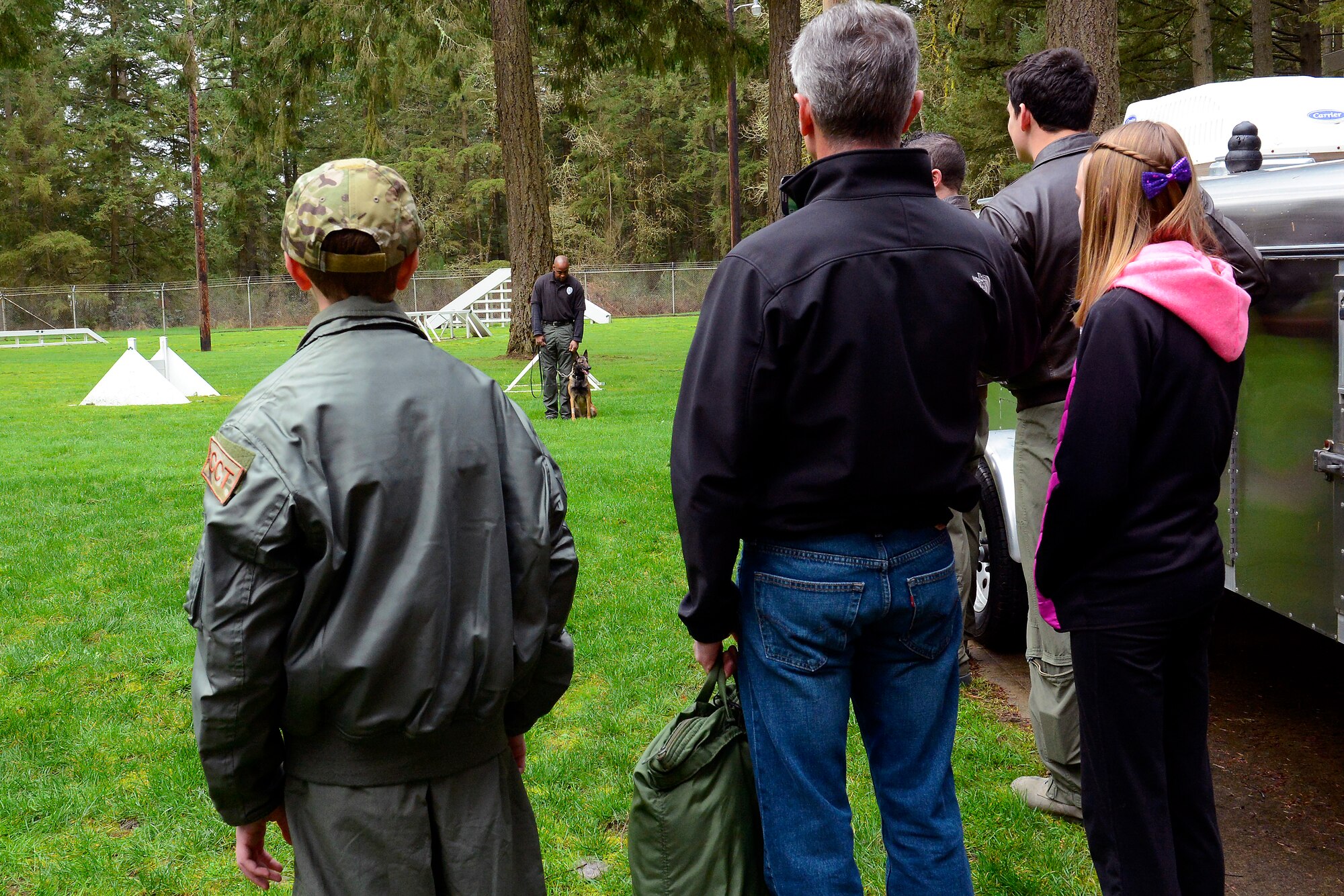 Carver Faull, 14-year-old Pilot for a Day participant, watches a demonstration of the capabilities of military working dogs, Feb. 20, 2015, at Joint Base Lewis-McChord, Wash. The canine officers showed off their abilities in illegal substance detection and suspect apprehension. (U.S. Air Force photo/Senior Airman Rebecca Blossom)