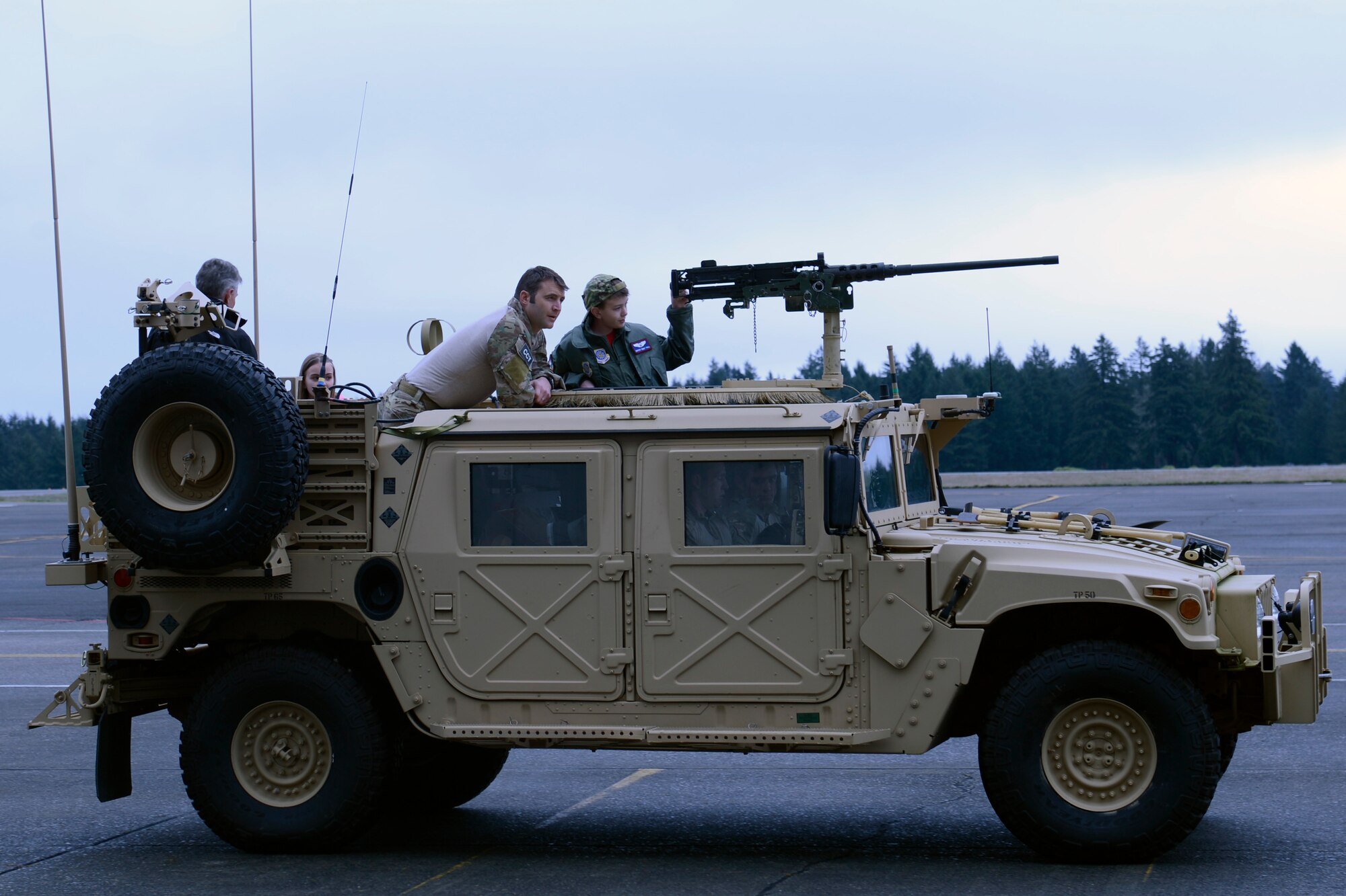 Carver Faull, McChord Field’s honorary Pilot for a Day, and his family take a ride on a Humvee, courtesy of the Airmen of the 22nd Special Tactics Squadron, Feb. 20, 2015, at Joint Base Lewis-McChord, Wash. “This event has been so important to us,” said Chief Master Sgt. Jeff Guilmain, 22nd STS superintendent. “We’re happy to be a part of it.” (U.S. Air Force photo/Senior Airman Rebecca Blossom)
