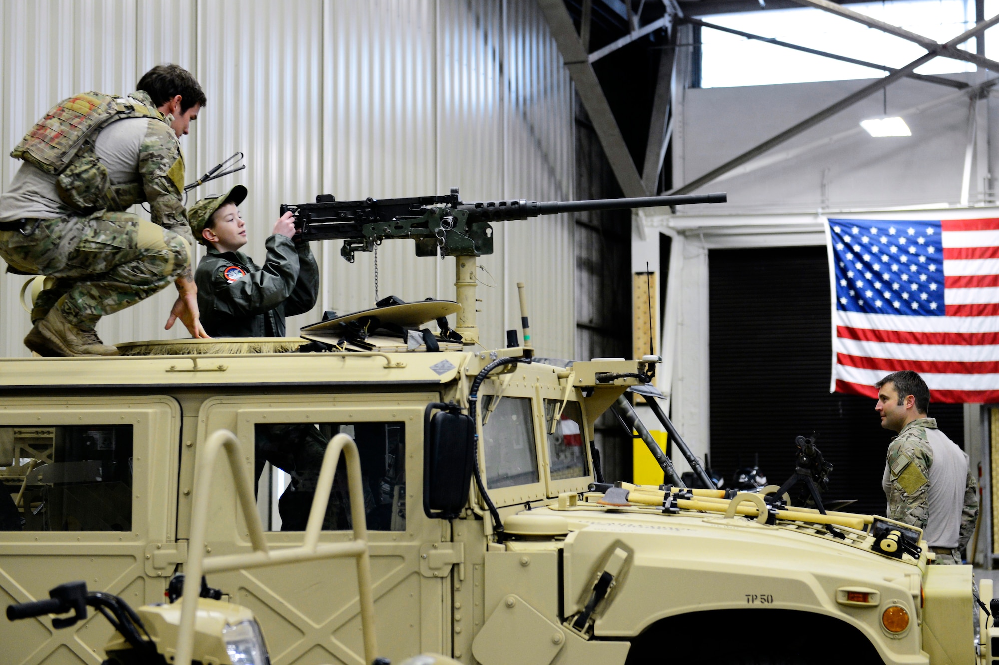 Airmen from the 22nd Special Tactics Squadron show Carver Faull, Pilot for a Day participant, how to look through the scope of a turret gun, Feb. 20, 2015, at Joint Base Lewis-McChord, Wash. The Airmen of 22 STS showed Carver their specialized equipment and demonstrated some of their unique skills. (U.S. Air Force photo/Senior Airman Rebecca Blossom)