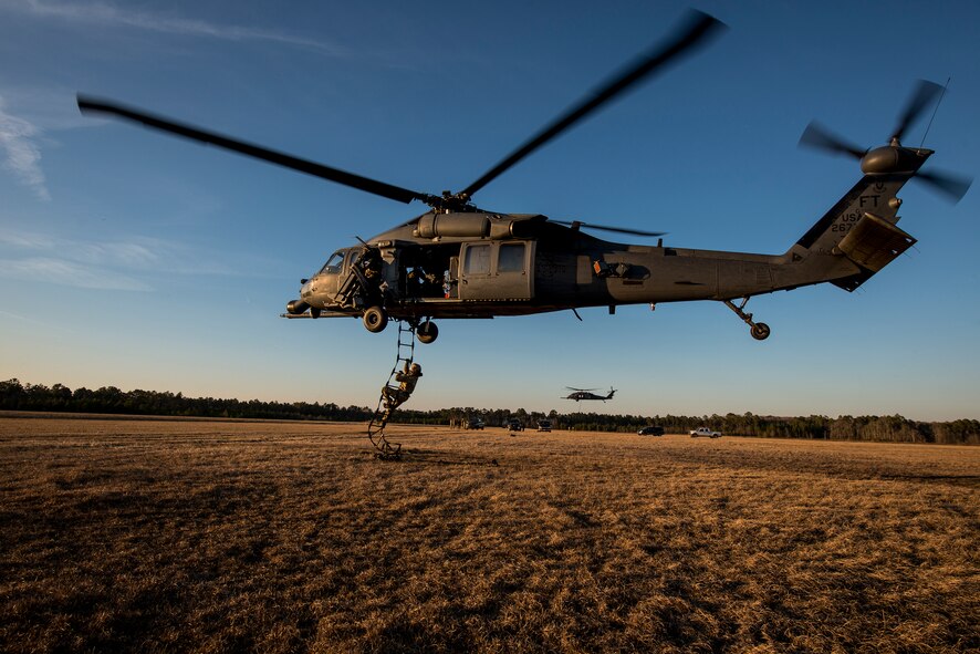 A pararescueman from the 38th Rescue Squadron climbs a ladder into an HH-60G Pave Hawk Feb. 19, 2015, at Moody Air Force Base, Ga. PJs train to enter and exit the aircraft through a variety of means to allow for situation-specific insertion and extraction options. (U.S. Air Force photo by Senior Airman Ryan Callaghan/Released)
