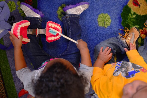 A child takes their turn brushing a tooth display during the 20th Dental Squadron’s visit to the Child Development Center, Shaw Air Force Base, S.C., Feb. 18, 2015. The DS went around to rooms within the CDC to show young children how to brush their teeth. (U.S. Air Force photo by Senior Airman Tabatha Zarrella/Released)