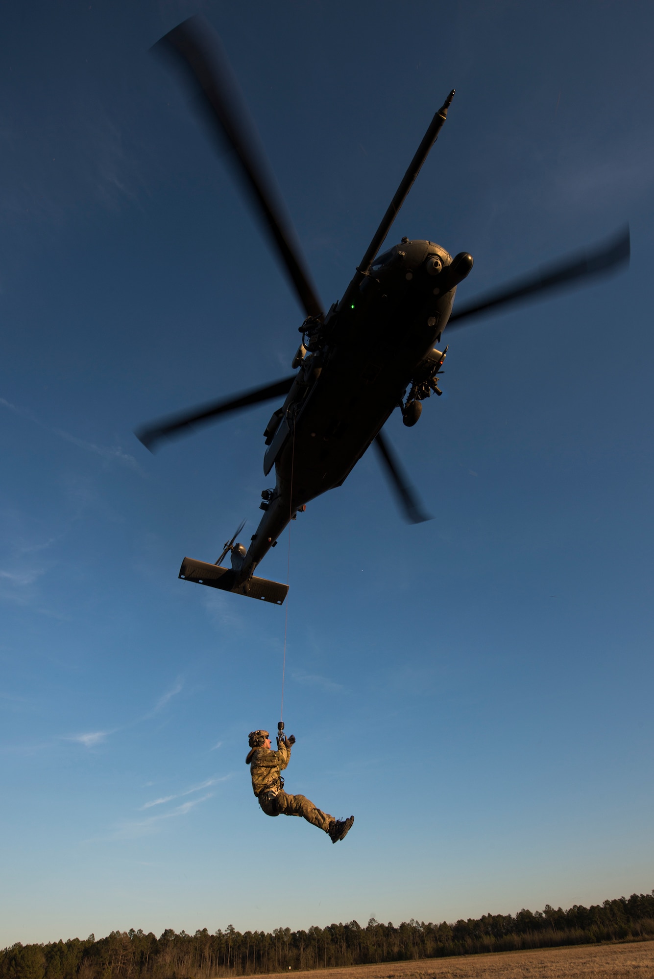 A pararescueman from the 38th Rescue Squadron is hoisted into an HH-60G Pave Hawk Feb. 19, 2015, at Moody Air Force Base, Ga. The 38th RQS regularly trains with the pilots and special missions aviators of the 41st RQS to provide the most realistic scenarios. (U.S. Air Force photo by Senior Airman Ryan Callaghan/Released)
