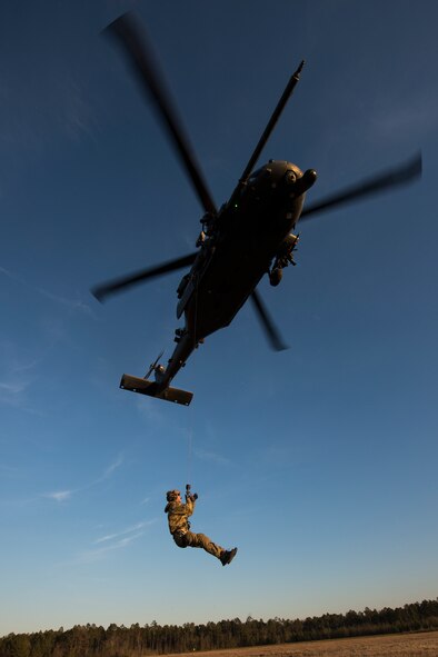 A pararescueman from the 38th Rescue Squadron is hoisted into an HH-60G Pave Hawk Feb. 19, 2015, at Moody Air Force Base, Ga. The 38th RQS regularly trains with the pilots and special missions aviators of the 41st RQS to provide the most realistic scenarios. (U.S. Air Force photo by Senior Airman Ryan Callaghan/Released)
