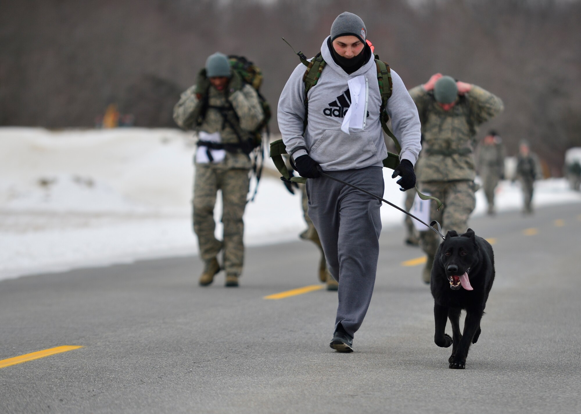Senior Airman Casey Wheatley, 436th Security Force Squadron military working dog handler, and his K-9, Veto, compete in the 16th Annual  Security Forces Ruck March Feb. 21, 2015, at Dover Air Force Base, Del. The course was 6.2 miles and runners were required to wear a 30-pound ruck sack for the entire event. (U.S. Air Force photo/Airman 1st Class William Johnson)