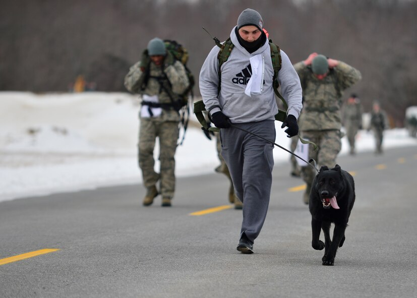 Senior Airman Casey Wheatley, 436th Security Force Squadron military working dog handler, and his K-9, Veto, compete in the 16th Annual  Security Forces Ruck March Feb. 21, 2015, at Dover Air Force Base, Del. The course was 6.2 miles and runners were required to wear a 30-pound ruck sack for the entire event. (U.S. Air Force photo/Airman 1st Class William Johnson)