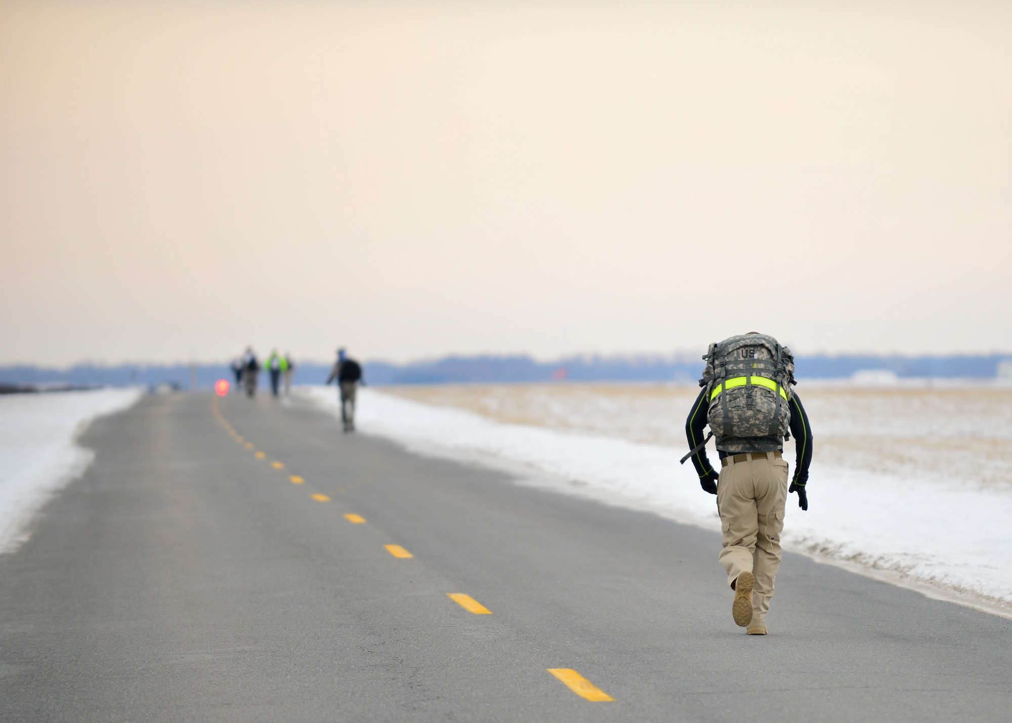Tim Howard, Delaware State Police trooper, runs down perimeter road with a 30-pound ruck sack during the 16th Annual Security Forces Ruck March Feb. 21, 2015, at Dover Air Force Base, Del. Temperatures reached as low as minus 1 degree Fahrenheit with the wind-chill during the 6.2 mile race. (U.S. Air Force photo/Airman 1st Class William Johnson)