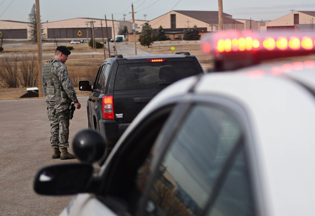 Airman 1st Class Hunter Harveston, 28th Security Forces Squadron response force member, stops a vehicle while on patrol at Ellsworth Air Force Base, S.D., Feb. 12, 2015. Patrolmen keep Ellsworth Airmen safe by enforcing driving laws on base. (U.S. Air Force photo by Airman 1st Class Zachary Hada/Released)