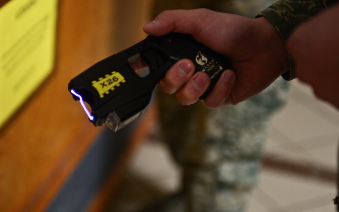A defender from the 28th Security Forces Squadron tests a taser from the 28th SFS Armory prior to signing it out at Ellsworth Air Force Base, S.D., Feb. 12, 2015. Tasers are useful tools used by security forces personnel because of the nonlethal capability they provide in detaining suspects. (U.S. Air Force photo by Airman 1st Class Zachary Hada/Released)