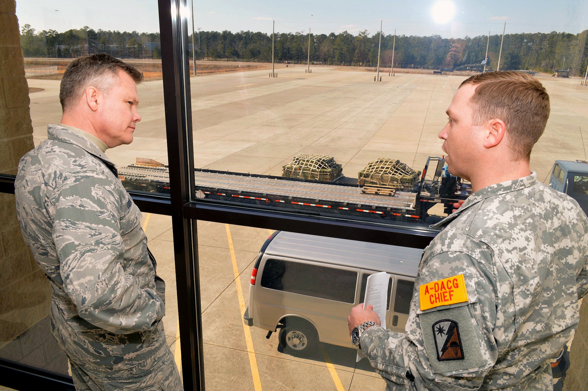Chief Warrant Officer 4 Jeremy Addleman, 330th Movement Control Battalion, 82nd Sustainment Brigade, briefs Brig. Gen. Tim Gibson, U.S. Air Force Expeditionary Center vice commander, about arrival-departure airlift control group operations supporting the Global Response Force mission during Gibson’s visit to the 43rd Airlift Group, Pope Army Airfield, N.C. Feb. 19-20. (U.S. Air Force photo/Marvin Krause)
