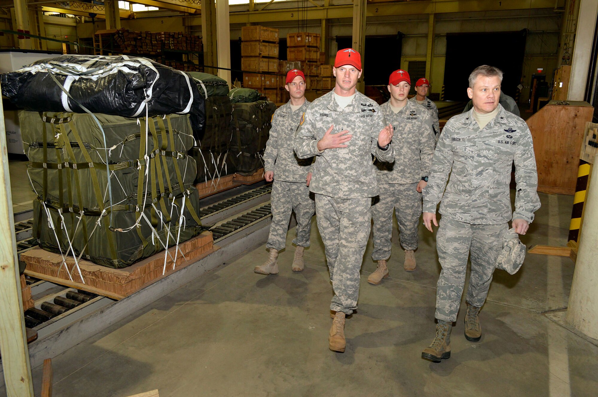 Warrant Officer Tommy Young, 11th Quartermaster Company, 82nd Sustainment Brigade, briefs Brig. Gen. Tim Gibson, U.S. Air Force Expeditionary Center vice commander, about heavy drop rigging operations supporting the Global Response Force mission during Gibson’s visit to the 43rd Airlift Group, Pope Army Airfield, N.C. Feb. 19-20. (U.S. Air Force photo/Marvin Krause)