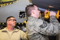 Air Force Reserve Staff Sgt. John Bordell, an aircraft metals technology specialist for the 910th Fabrication Flight, extracts a stripped screw from a leading edge access panel on the wing of a C-130H Hercules aircraft here, Feb. 7, 2015. Tech. Sgt. Ross Gordon, Noncommissioned Officer in Charge of the 910th Fabrication Flight, assists Bordell in the procedure, which falls under the flight’s specialty field of fabrication of aircraft structural components. U.S. Air Force photo by Tech. Sgt. Rick Lisum.