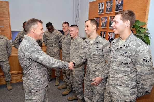 Brig. Gen. Tim Gibson, U.S. Air Force Expeditionary Center vice commander, shakes hands with Staff Sgt. Wesley Cure, 43rd Comptroller Flight, during Gibson’s visit to the 43rd Airlift Group, Pope Army Airfield, N.C. Feb. 19-20. (U.S. Air Force photo/Marvin Krause)