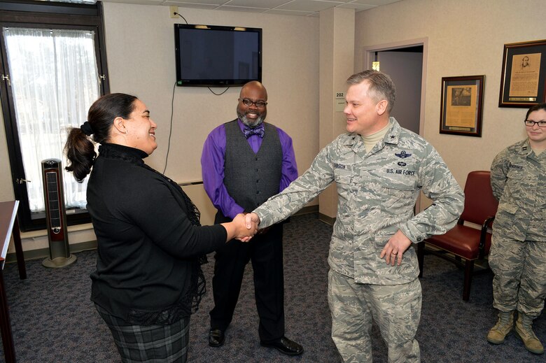 Brig. Gen. Tim Gibson, U.S. Air Force Expeditionary Center vice commander, presents the Expeditionary Center commander’s coin to Patricia Bradley, chief of civil law, 43rd Legal Office, recognizing her outstanding duty performance during Gibson’s visit to the 43rd Airlift Group, Pope Army Airfield, N.C. Feb. 19-20. (U.S. Air Force photo/Marvin Krause)