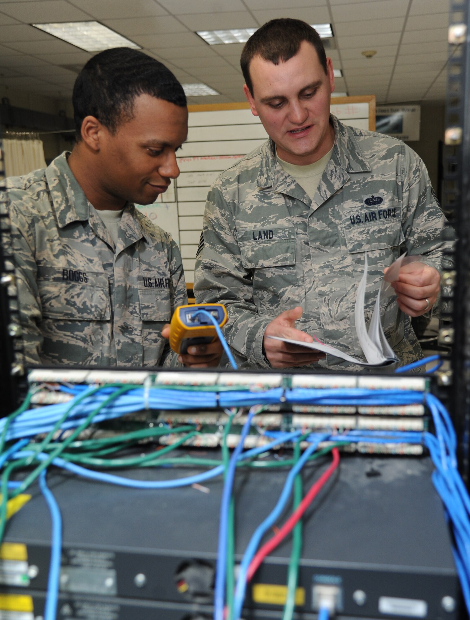 Airman 1st Class Gary Boggs, 338th Training Squadron student, receives instruction from Staff Sgt. John Land, 338th TRS instructor, while testing the through-put of the internet protocol network during the cyber transport course Feb. 18, 2015, at Bryan Hall, Keesler Air Force Base, Miss.  (U.S. Air Force photo by Kemberly Groue)
