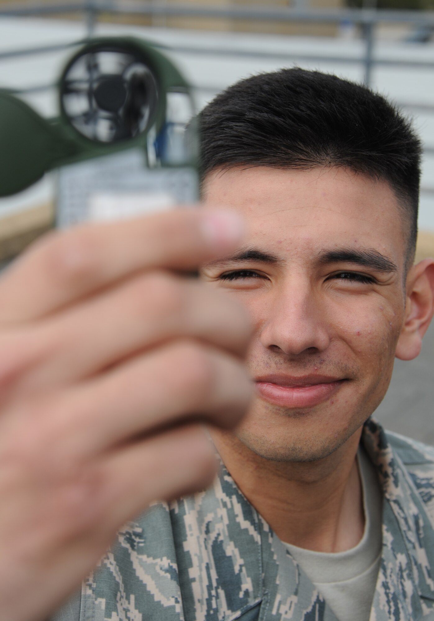 Airman Basic Alan Ortega, 335th Training Squadron student, uses a kestrel to conduct a manual weather observation during the initial skills course from the weather observatory Feb. 19, 2015, Keesler Air Force Base, Miss..  (U.S. Air Force photo by Kemberly Groue)