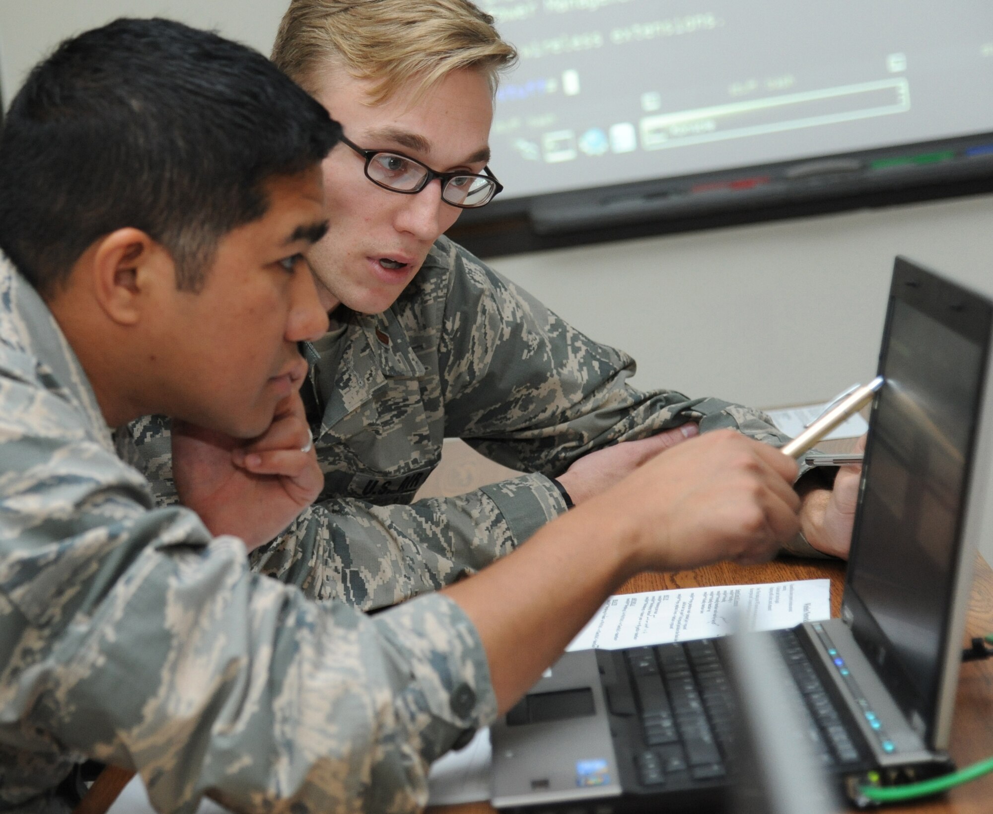 Second Lts. Gregory Garcia and Thomas Denninghoff, 333rd Training Squadron undergraduate cyber training students, conduct a vulnerability assessment during the introduction to offensive cyber operations course Feb. 18, 2015, at Stennis Hall, Keesler Air Force Base, Miss. (U.S. Air Force photo by Kemberly Groue)