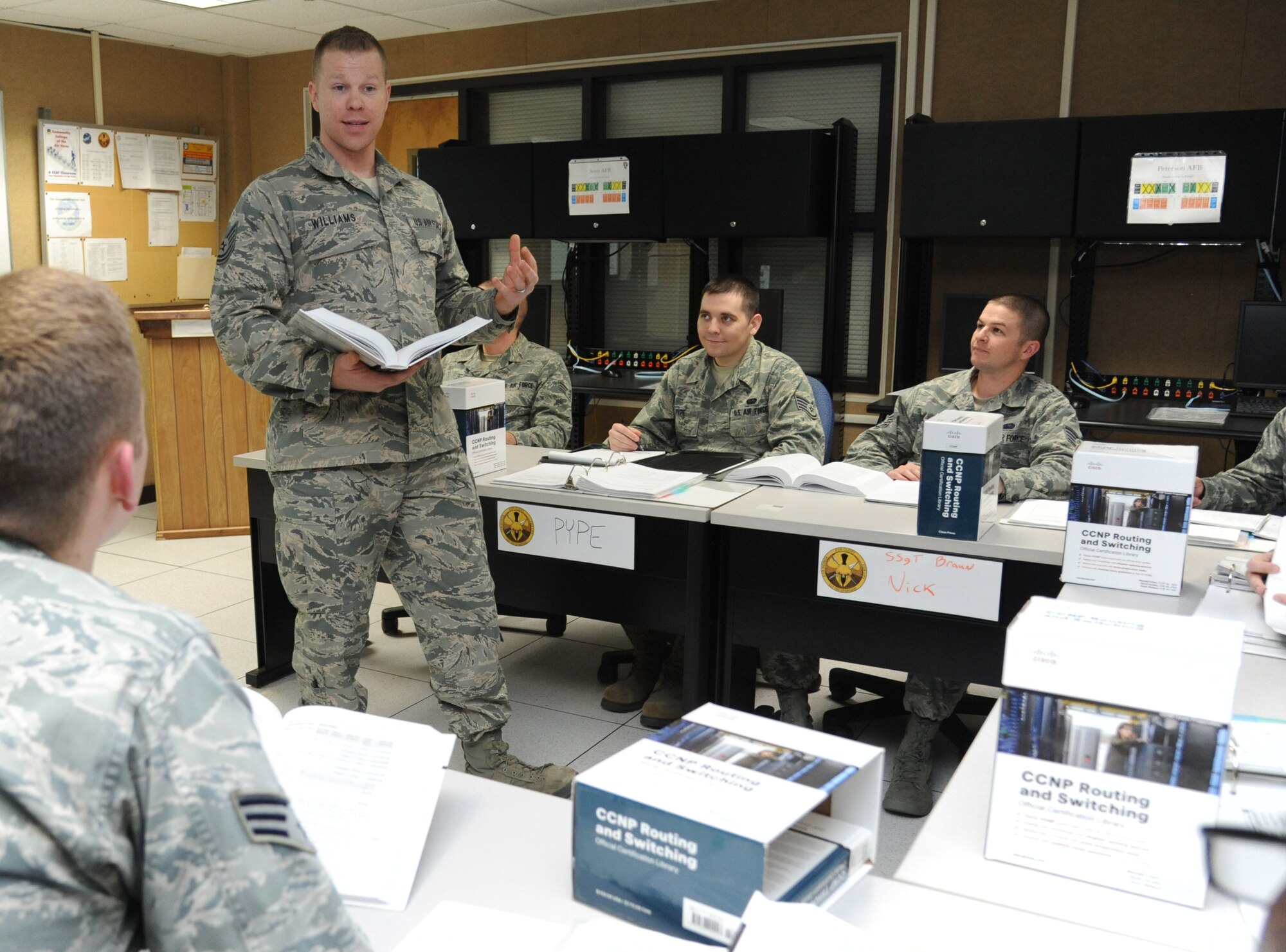 Tech. Sgt. Joshua Williams, 333rd Training Squadron network management infrastructure professional course instructor, teaches a lesson to his class Feb. 18, 2015, at Stennis Hall, Keesler Air Force Base, Miss. (U.S. Air Force photo by Kemberly Groue)