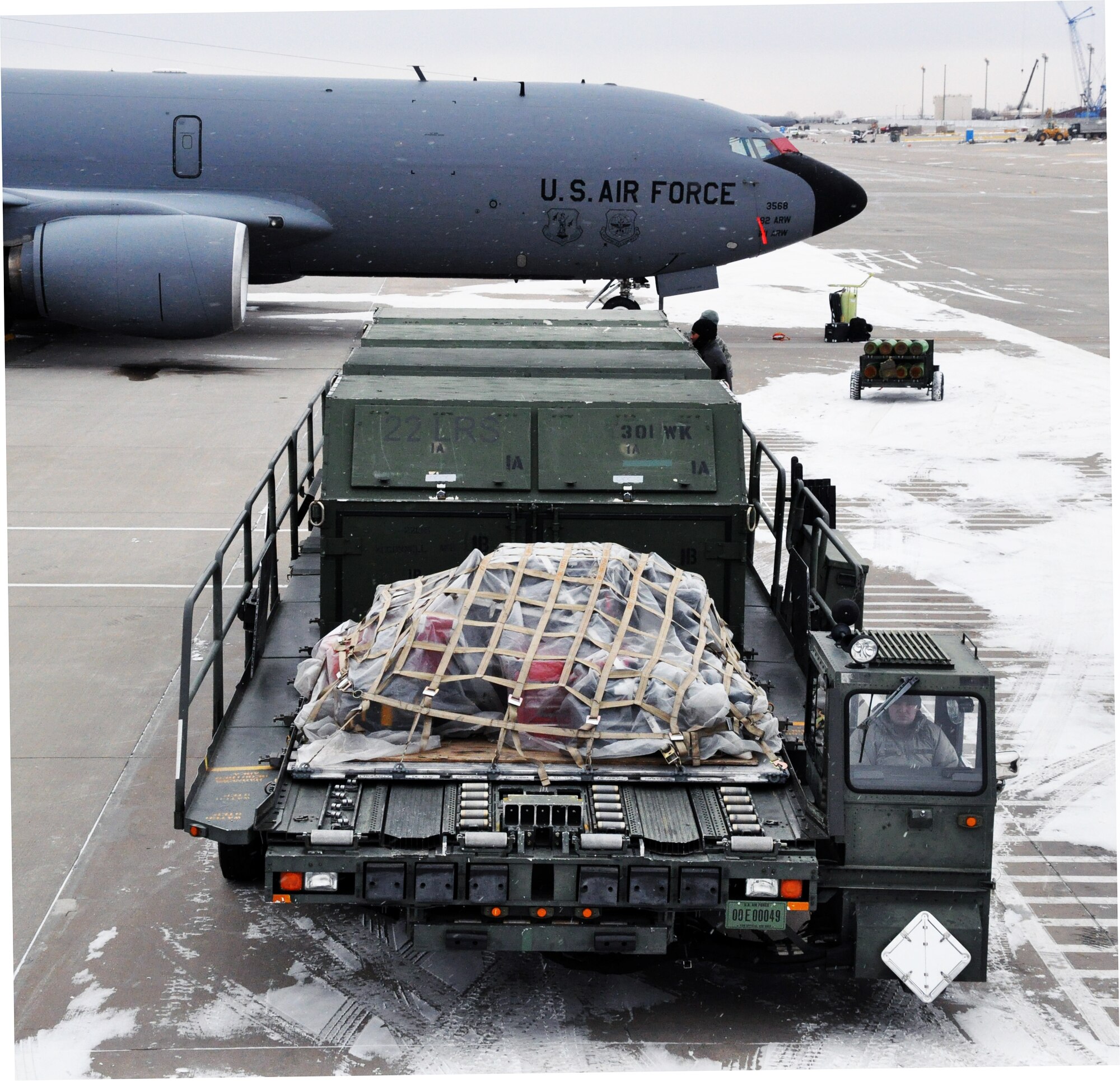 A K-loader waits on the flightline at McConnell Air Force Base, Kan., in preparation for loading pallets of cargo onto a KC-135 Stratotanker, Feb. 23, 2015.  A total force team of logistics personnel and air refueling boom operators from the active duty 22 ARW and Air Force Reserve 931st Air Refueling Group braved sub-freezing temperatures to load approximately 18,000 pounds of cargo onto the aircraft in preparation for Red Flag. Red Flag is a large-scale military training exercise conducted at Nellis Air Force Base, Nev. (U.S. Air Force photo by Capt. Zach Anderson)  