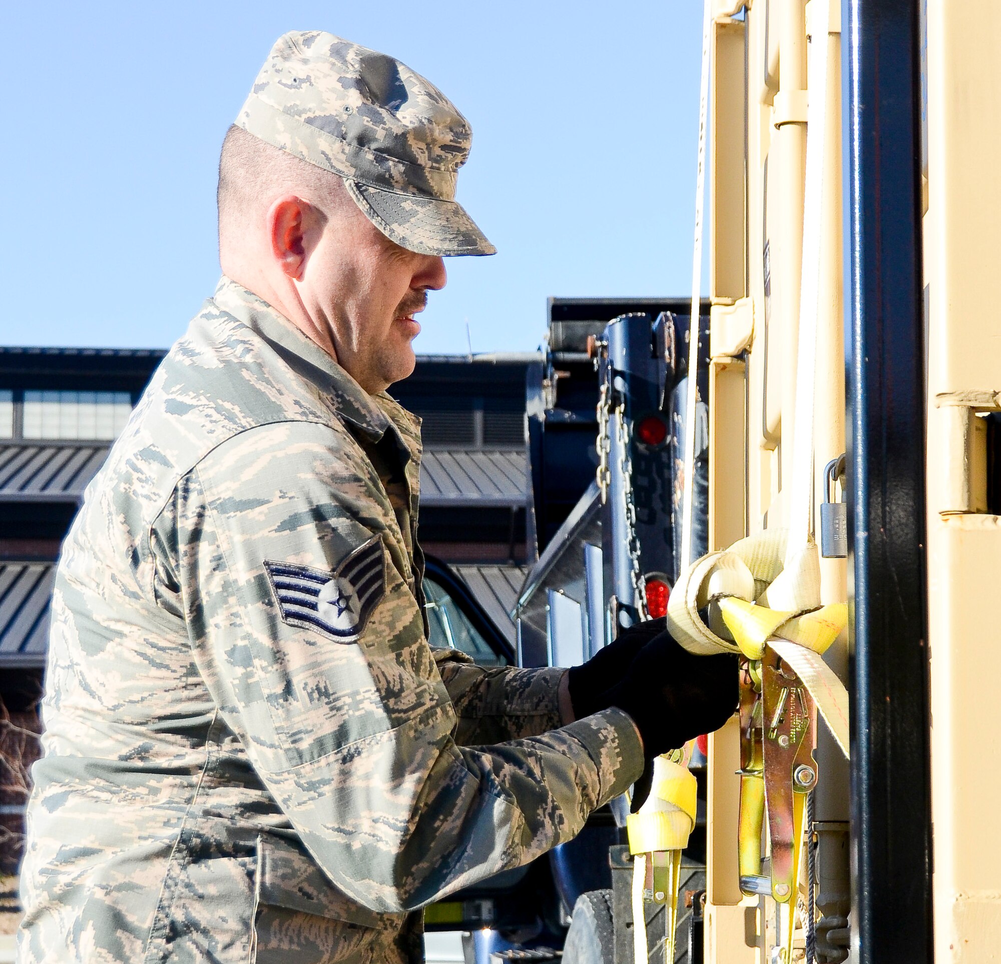 A U.S. Air Force Staff Sgt. Jerry Vincent from the 116th Civil Engineering Squadron (CES), Georgia Air National Guard, ties down a conex bin to a flat-bed trailer in preparation for movement to Dobbins Air Reserve Base in response to the Defense Support of Civil Authorities (DSCA) preparation for the potential of inclement weather, Robins Air Force Base, Ga., Feb. 18, 2015. The CES supports the DSCA by utilizing military assets and personnel when authorized by the governor.  The CES provides initial route clearance in response to natural and man-made disasters. (U.S. Air National Guard photo by Tech. Sgt. Regina Young/released) 

