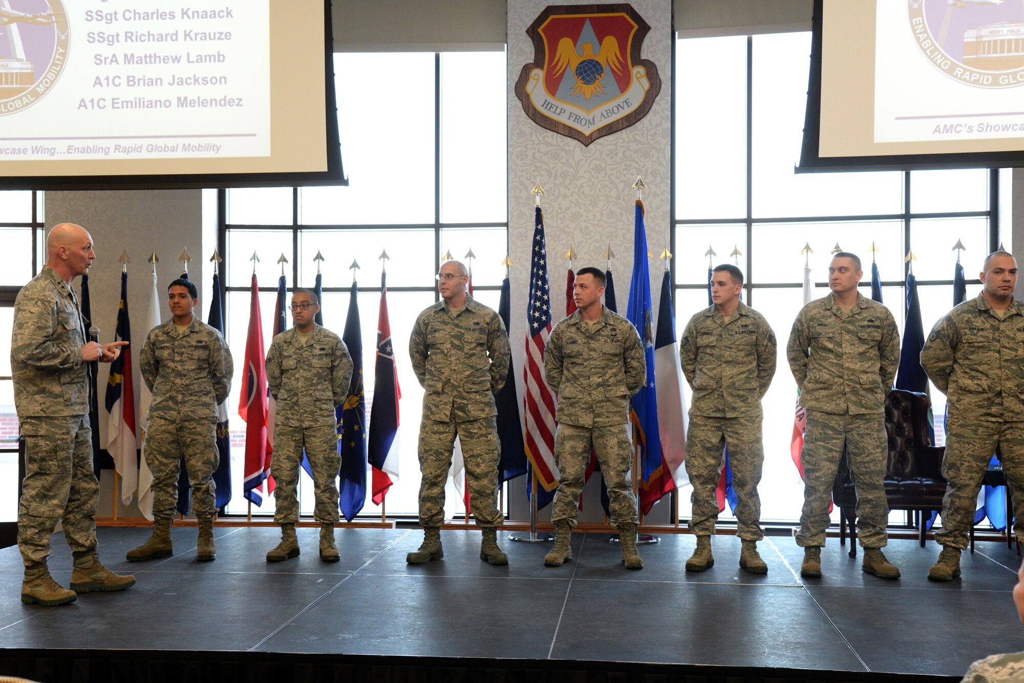 Maj. Gen. Timothy Zadalis, 618th Air Operations Center commander speaks to and coins Airmen from the 375th Logistics Readiness Squadron Feb. 19 at the Scott Club, Scott Air Force Base, Ill. Zadalis awarded them with the coins for being innovative and saving the Air Force over $96,000. (U.S. Air Force photo/ Airman 1st Class Megan Friedl)