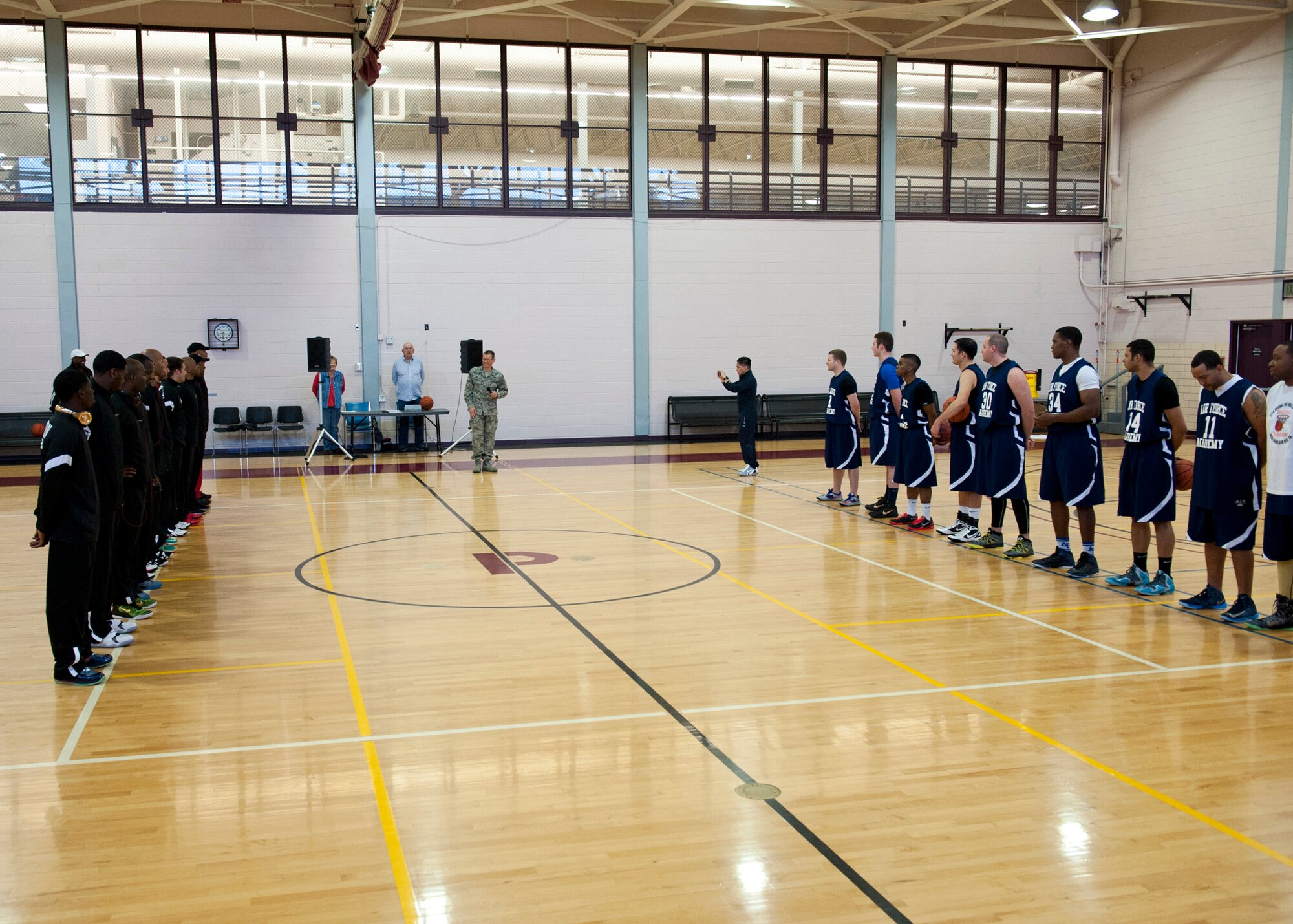 PETERSON AIR FORCE BASE, Colo. – Col. Reginald Ash III, 21st Space Wing Mission Support Group commander, speaks to the Peterson AFB and U.S. Air Force Academy teams before the first basketball game of the weekend tournament at the Peterson AFB gym, Feb. 14, 2015. Teams from F.E. Warren AFB, Fort Carson and Buckley AFB also participated in the tournament. Peterson AFB won against F.E. Warren 81-67 in the championship game Feb. 15, 2015. (U.S. Air Force photo by Senior Airman Tiffany DeNault)