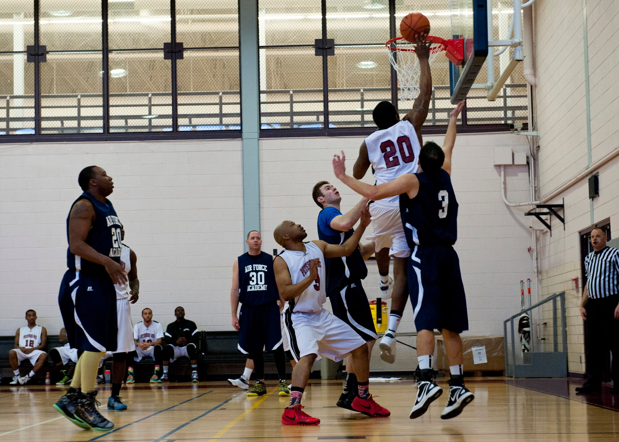 PETERSON AIR FORCE BASE, Colo. – Members of the Peterson AFB and the U.S. Air Force Academy basketball team participate in a tournament at the Peterson AFB gym, Feb. 14, 2015. Teams from F.E. Warren AFB, Fort Carson and Buckley AFB also participated in the tournament. Peterson AFB defeated F.E. Warren 81-67 in the championship game Feb. 15, 2015. (U.S. Air Force photo by Senior Airman Tiffany DeNault)