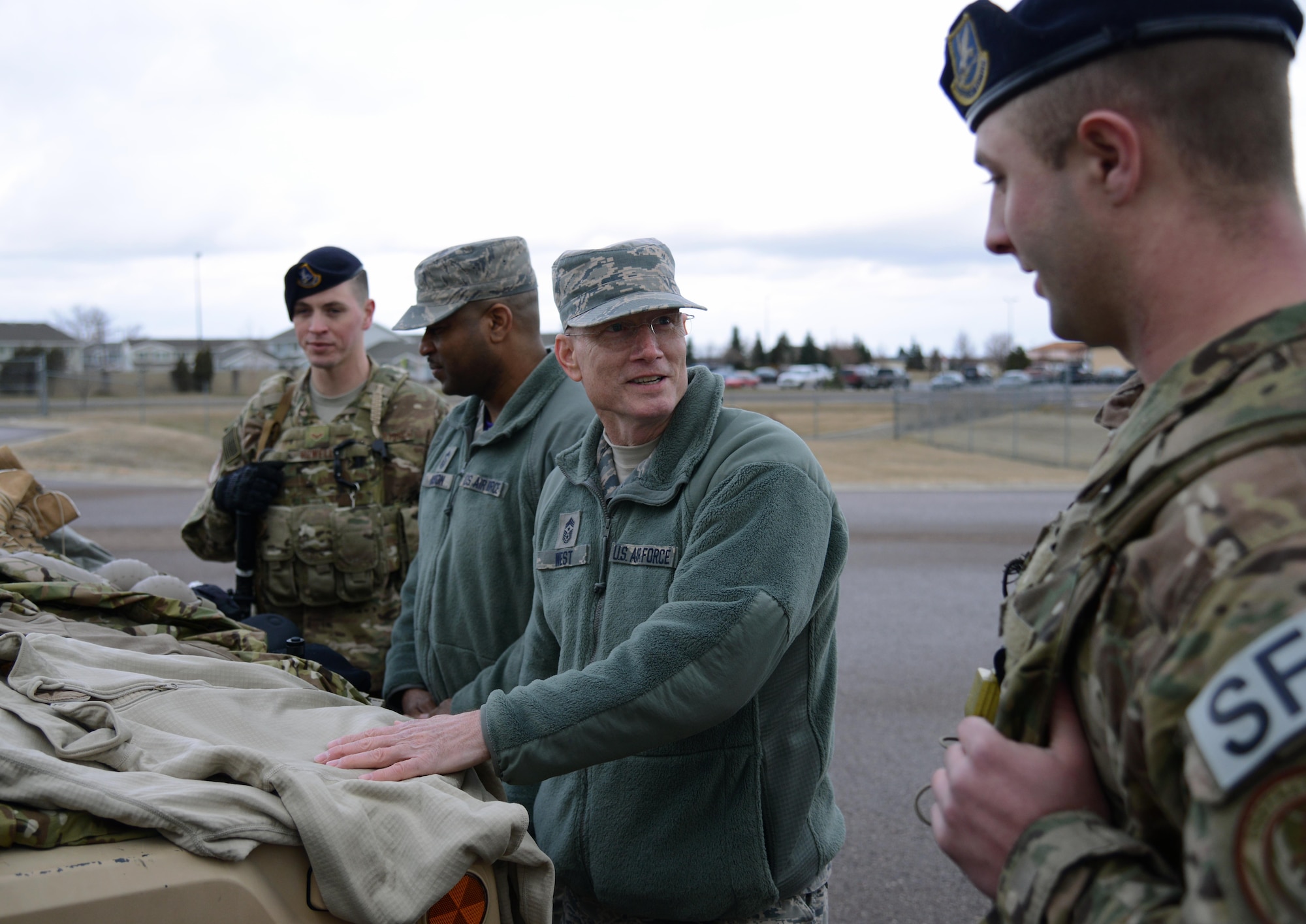 Chief Master Sgt. Terry West, second from right, Air Force Global Strike Command command chief, speaks with security forces Airmen about their new Model Defender equipment Feb. 20 at Malmstrom Air Force Base, Mont. West visited the base to tour its facilities and speak with Team Malmstrom members about the Force Improvement Program. (U.S. Air Force photo/Airman 1st Class Dillon Johnston)