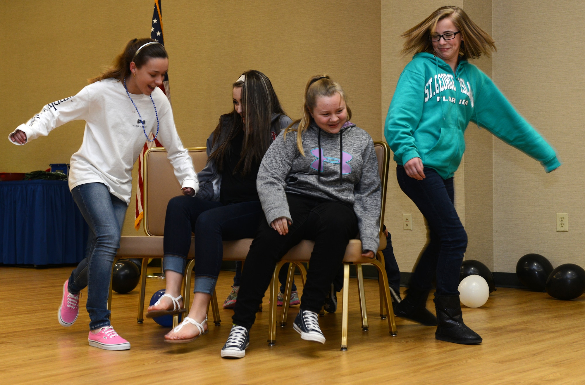 Team Moody members play musical chairs during the Mardis Gras family dinner Feb. 19, 2015, at Moody Air Force Base, Ga. The Moody Field Club holds these family nights quarterly. (U.S. Air Force photo by Airman 1st Class Kathleen D. Bryant/Released)