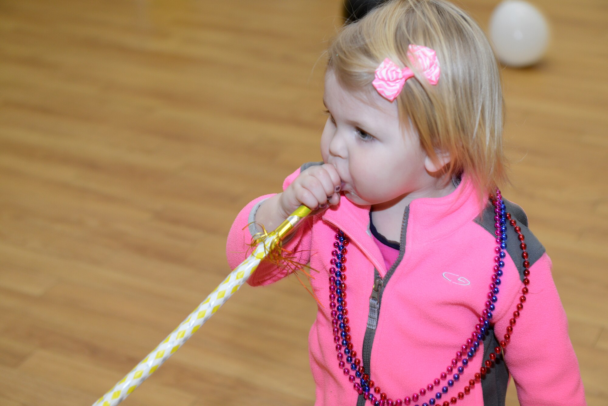 Kaylen Jenkins, daughter of U.S. Air Force Senior Airmen Matthew Jenkins, 23d Force Support Squadron, blows a party horn during the Mardis Gras family dinner Feb. 19, 2015, at Moody Air Force Base, Ga. The children participated in activities such as musical chairs and mask-making. (U.S. Air Force photo by Airman 1st Class Kathleen D. Bryant/Released)