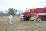 Lt. Darren Fehlinder (left) and Senior Airman Olsen Brett (center), both Joint Base San Antonio-Randolph firefighters, and Kasey Klause, City of Seguin firefighter, secure the site of a simulated aircraft accident during a major accident response exercise Feb. 5 at the Joint Base San Antonio-Randolph Seguin Auxiliary Airfield. A MARE is intended to test the ability of first responders and other agencies to handle various emergency scenarios, in this instance, a T-38 crash off-base that involved assistance from local community first responders. (U.S. Air Force photo by Joel Martinez) 