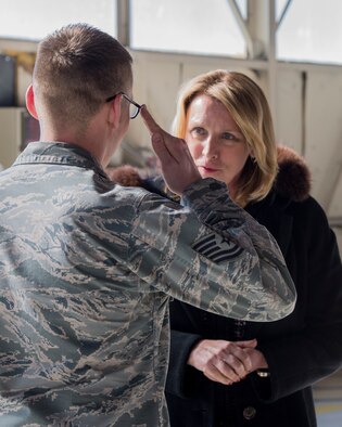 Tech. Sgt. Chad Thompson, 366th Operation Support Squadron NCO in charge of air traffic controller training, salutes Secretary of the Air Force Deborah Lee James during her visit to Mountain Home Air Force Base, Idaho, Feb. 18, 2015. James coined Thompson for being a superior performer. (U.S. Air Force photo by Airman 1st Class Jessica H. Smith/RELEASED)