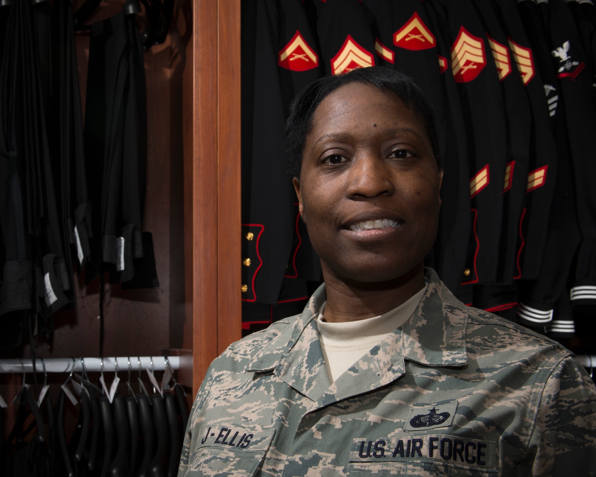 Master Sgt. Enid J-Ellis, 512th Memorial Affairs Squadron, Dover Air Force Base, Del., poses in the uniform preparation section of the Charles C. Carson Center for Mortuary Affairs Feb. 23, 2015. J-Ellis, is currently serving on her fourteenth deployment to the mortuary. She is pursuing a career as a funeral director as a result of her experience. (U.S. Air Force photo by Capt. Raymond Geoffroy)