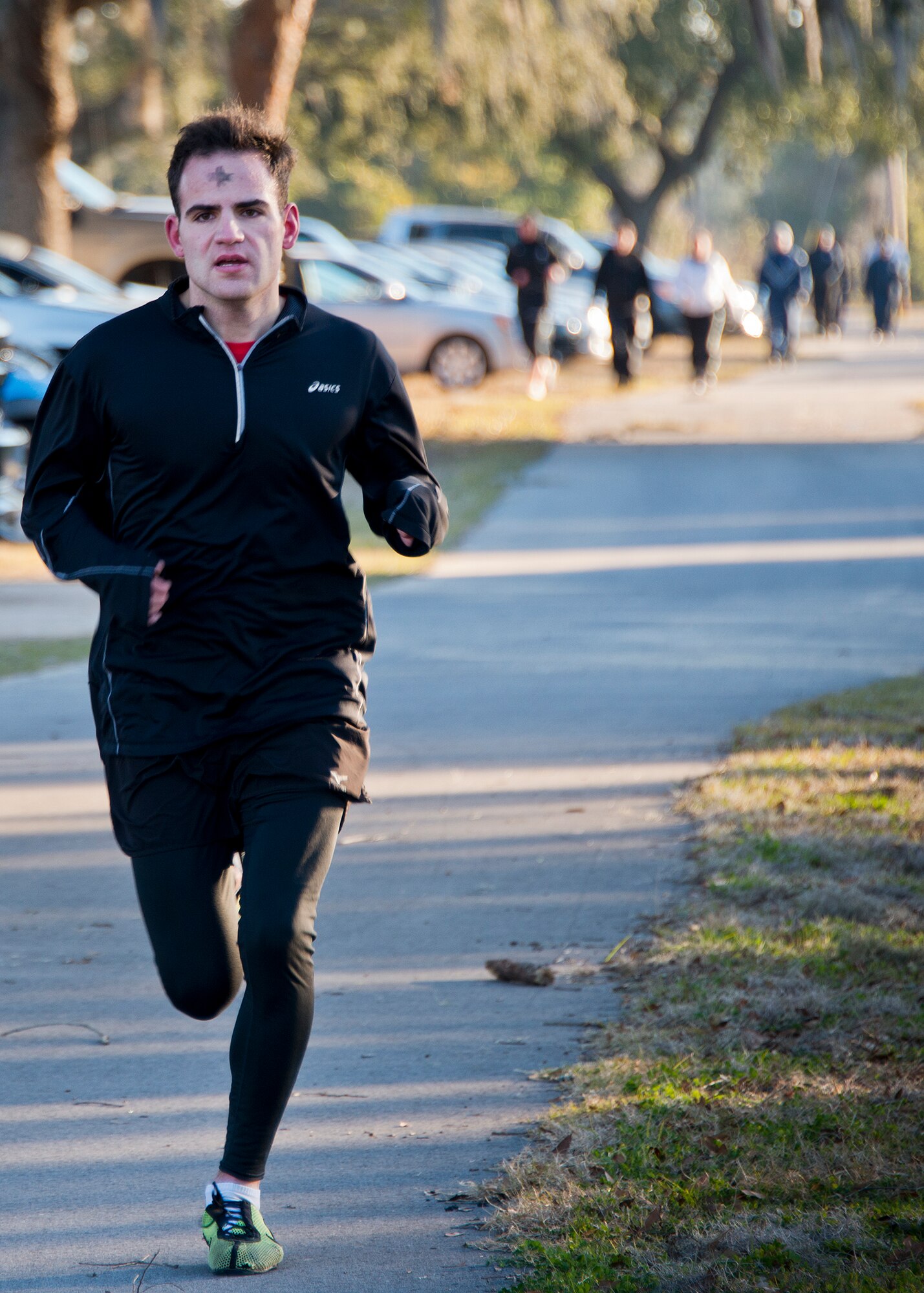 Airman 1st Class Zachary Brady, of the 88th Medical Operations Squadron, races to the finish line of the Ash Wednesday, Ashes to Dust 5K Feb. 18 near the Civil Engineering Pavilion on Eglin Air Force Base, Fla.  Approximately 225 people attended the event.  Ash Wednesday marks the beginning of the Lent season for Christians.  Eglin’s Chapel held the event to start the season with spiritual and physical inspiration and also the option to receive a cross of ashes for those who wanted to demonstrate their faith. (U.S. Air Force photo/Ilka Cole)