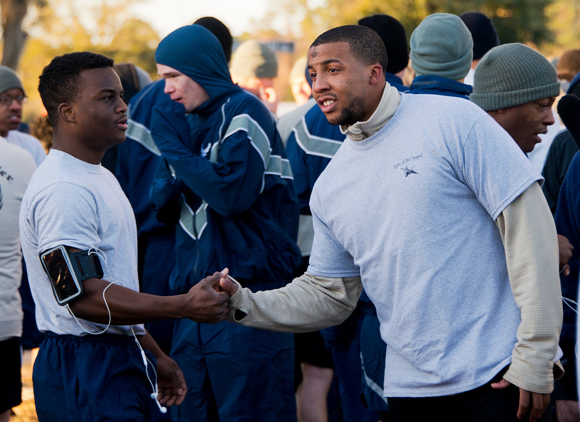Participants greet and shake hands at the start line of the Ashes to Dust 5K Feb. 18 near the Civil Engineering Pavilion on Eglin Air Force Base, Fla. Approximately 225 people attended the event on Ash Wednesday, a day that marks the beginning of the Lent season for Christians.  Eglin’s Chapel held the event to start the season with spiritual and physical inspiration and also the option to receive a cross of ashes for those who wanted to demonstrate their faith. (U.S. Air Force photo/Ilka Cole)